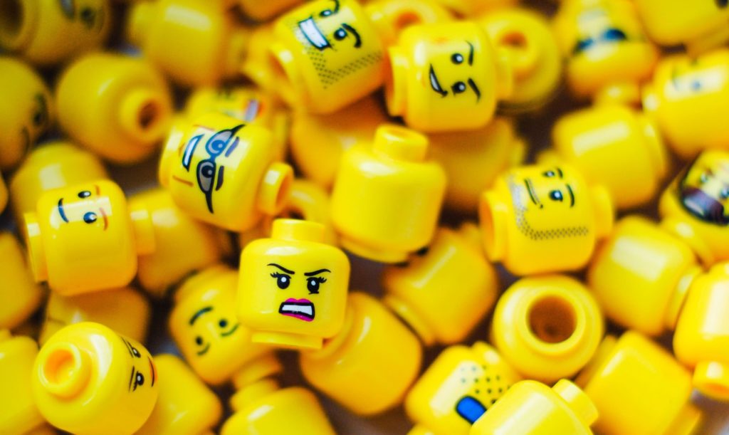 pile of lego heads showing different emotions and brand personality